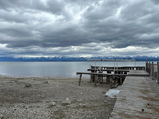 view of dock with a water and mountain view