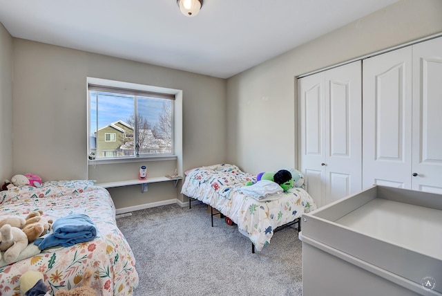 bedroom with a closet, baseboards, and carpet flooring