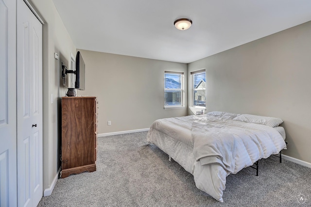 carpeted bedroom featuring baseboards