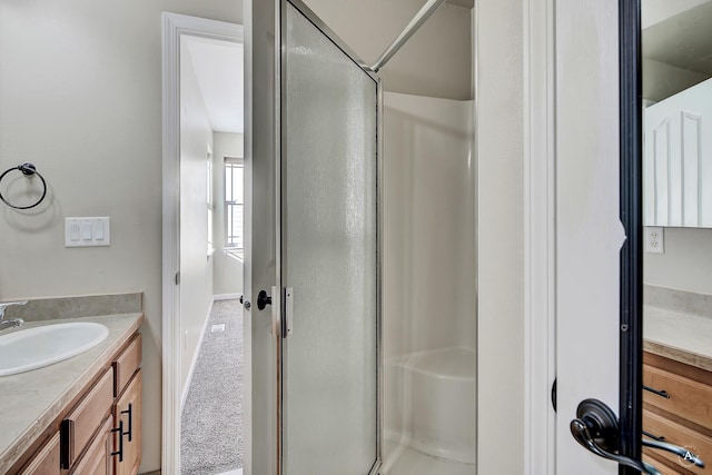 full bathroom featuring a shower stall, vanity, and baseboards