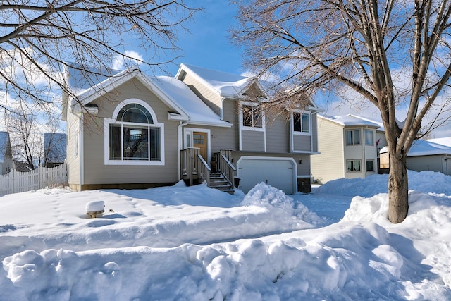 view of front of house featuring a garage and fence