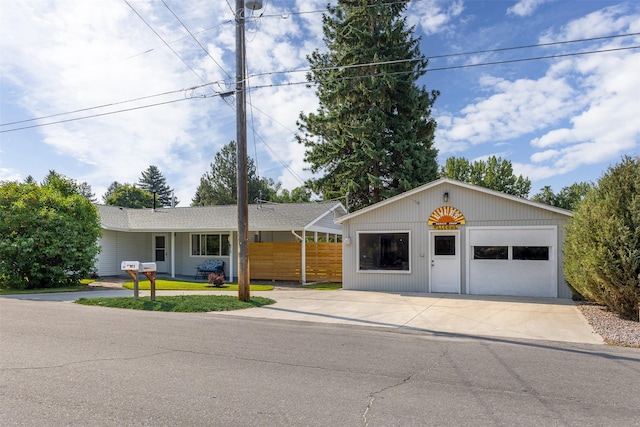 single story home with a garage and fence