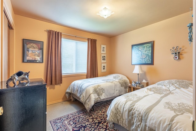 bedroom featuring carpet floors and baseboards