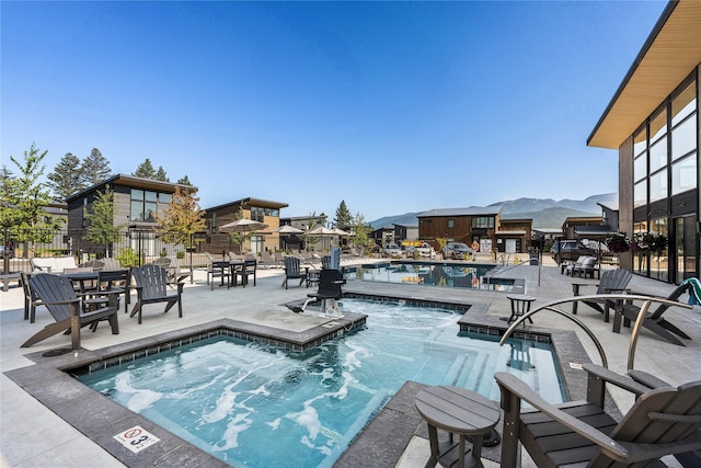 288 Boulders Rd Unit B21, Whitefish, MT 59937 - community pool with a patio, a mountain view, and fence