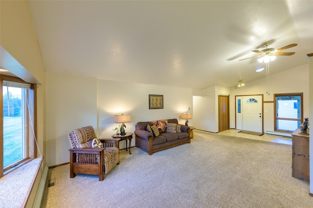 4901 Hoblitt Ln S, Florence, MT 59833 - living area featuring lofted ceiling, carpet floors, plenty of natural light, ceiling fan, and a baseboard radiator