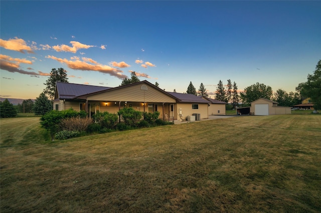 4901 Hoblitt Ln S, Florence, MT 59833 - rear view of property featuring a garage, a lawn, an outdoor structure, and metal roof