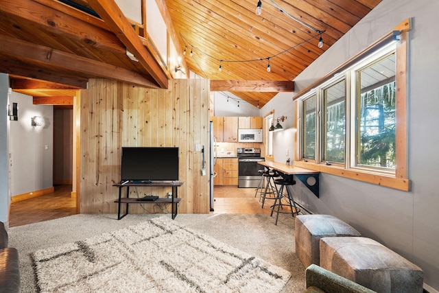 living room with vaulted ceiling with beams, wood walls, wood ceiling, and track lighting