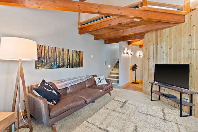 37 Alder Way, Whitefish, MT 59937 - living area with carpet floors, beamed ceiling, stairway, and wood walls