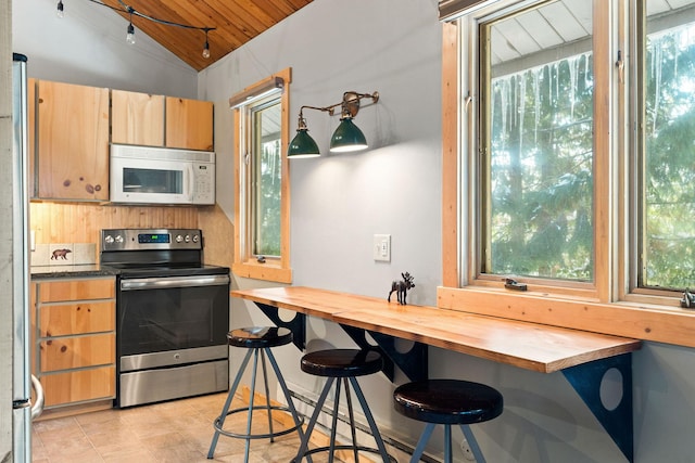 37 Alder Way, Whitefish, MT 59937 - kitchen with white microwave, stainless steel electric range oven, vaulted ceiling, wooden ceiling, and butcher block countertops