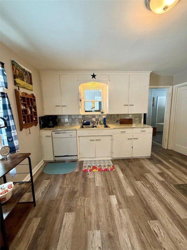 kitchen featuring a sink, white cabinetry, light countertops, backsplash, and dishwasher