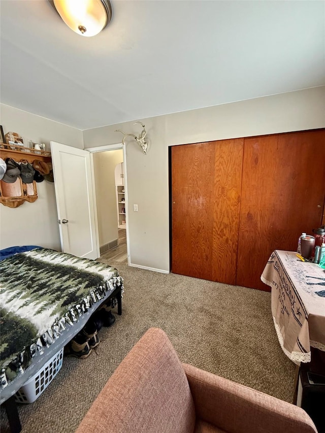 bedroom with carpet floors and baseboards