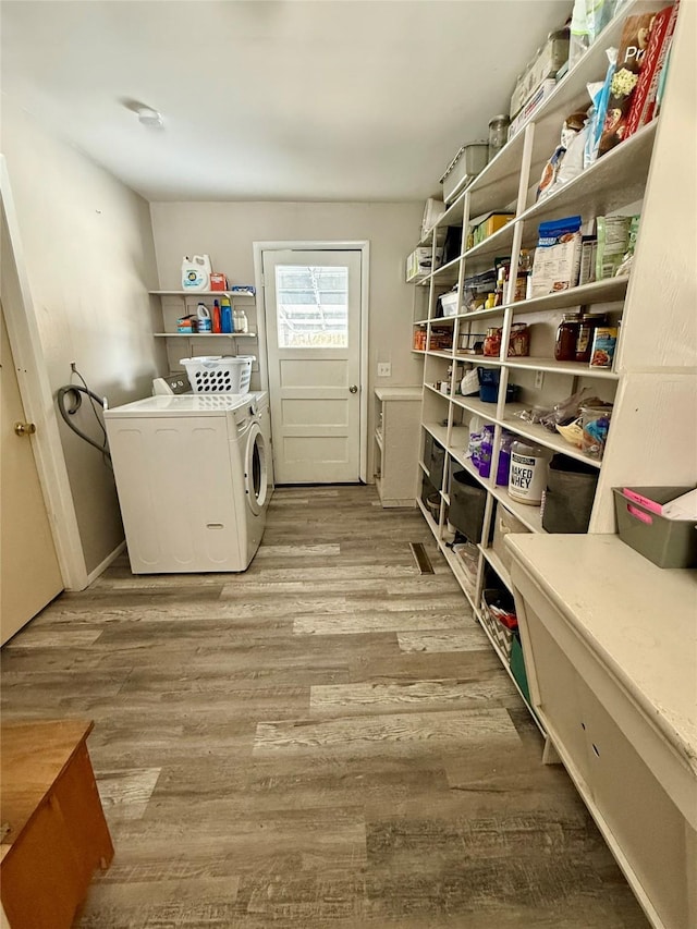 washroom featuring laundry area, light wood-style floors, and washer and dryer