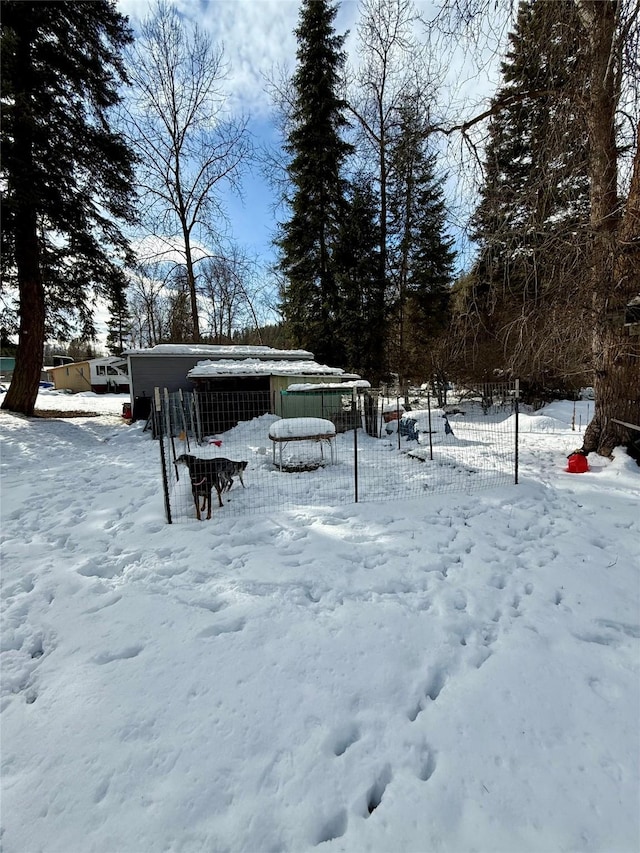 yard layered in snow featuring fence