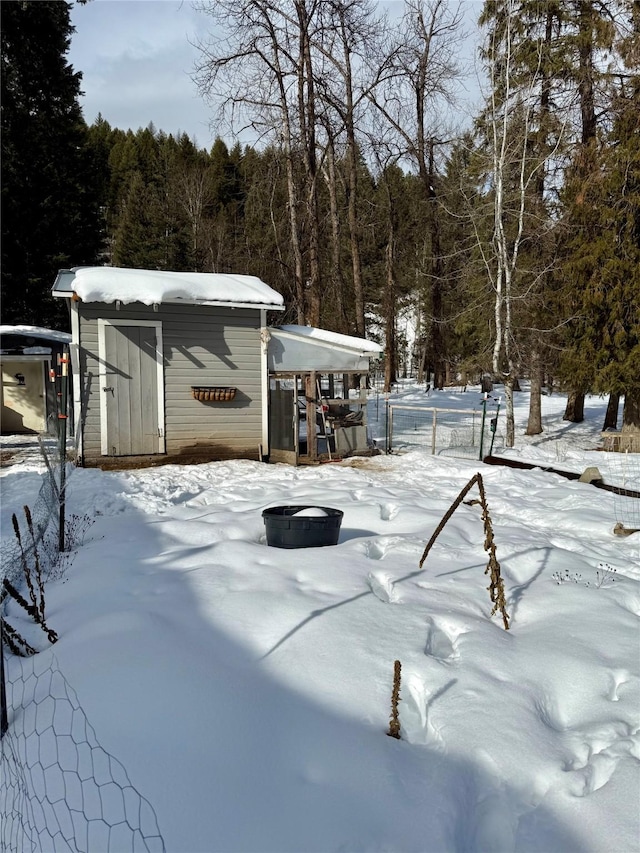 yard covered in snow with fence