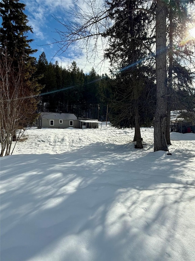 view of yard layered in snow