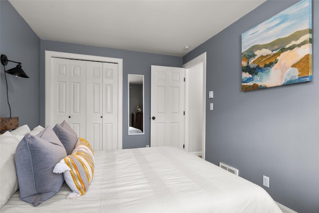 bedroom with visible vents and a closet