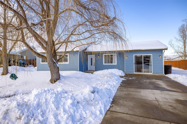 ranch-style home with fence