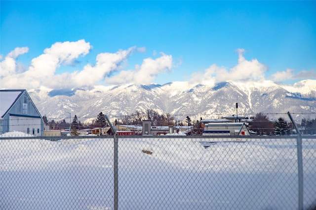 exterior space featuring a mountain view and fence