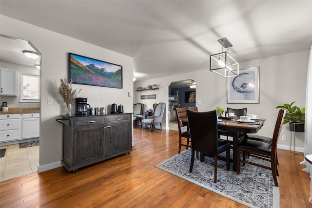 dining space featuring ceiling fan, baseboards, and wood finished floors