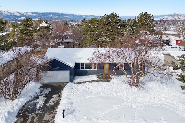 snowy aerial view with a mountain view