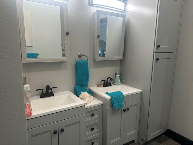 bathroom with two vanities and a sink