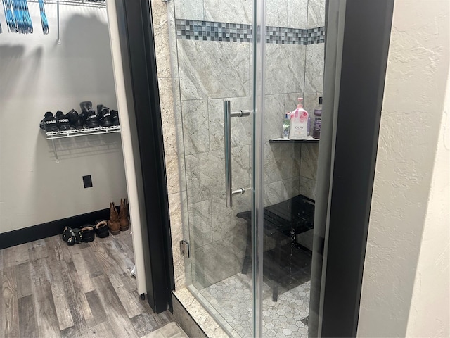 bathroom featuring a stall shower and wood finished floors