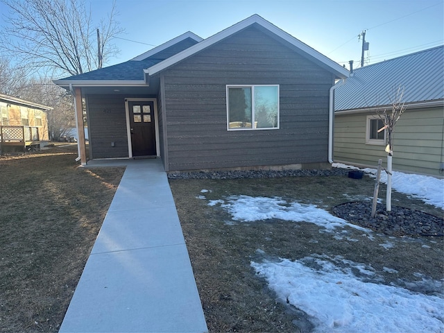 view of front of home featuring roof with shingles