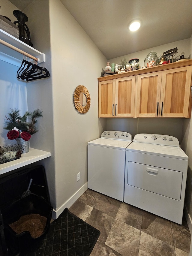 washroom featuring cabinet space, independent washer and dryer, and baseboards