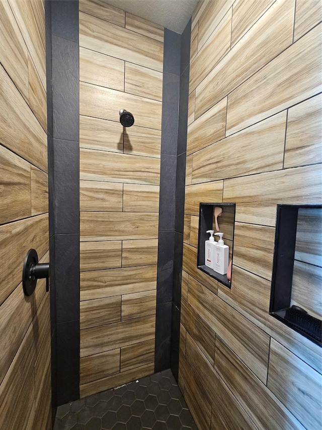 interior details featuring tiled shower