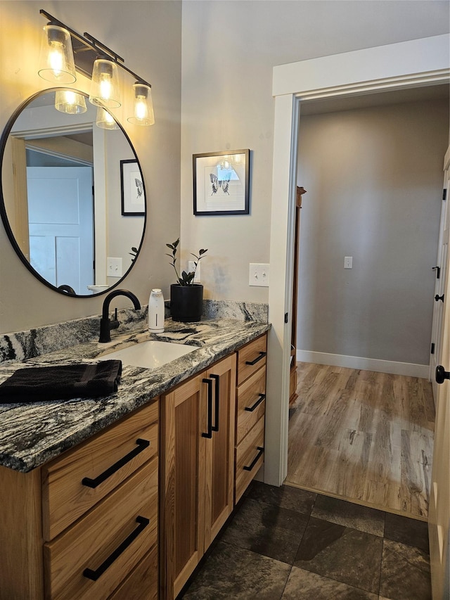 bathroom with vanity and baseboards