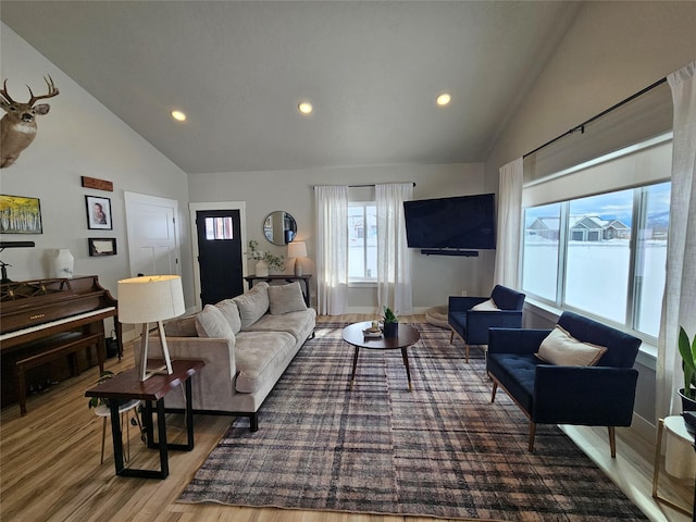 living area featuring high vaulted ceiling, wood finished floors, and recessed lighting