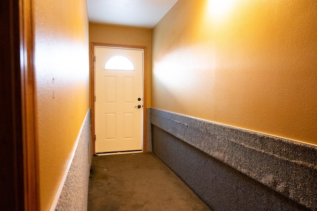 doorway with carpet floors