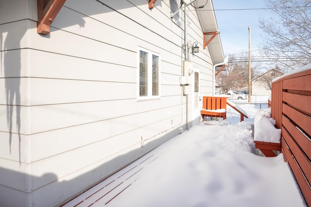 view of snow covered exterior featuring fence