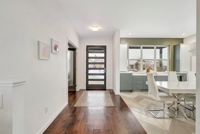 foyer with recessed lighting, wood finished floors, and baseboards