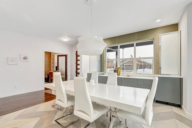 dining room with light wood-style floors, baseboards, and recessed lighting