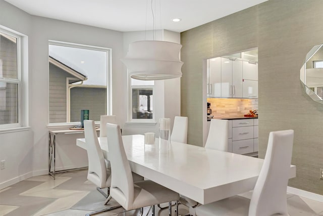 dining room with recessed lighting and baseboards