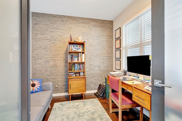 office area with baseboards and dark wood-type flooring