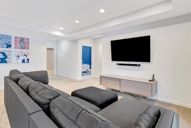 living area with recessed lighting, a raised ceiling, light colored carpet, and baseboards