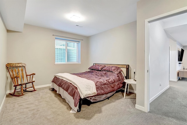 bedroom with baseboards, visible vents, and light colored carpet