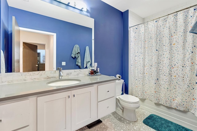 full bath with toilet, tile patterned floors, vanity, and shower / tub combo with curtain