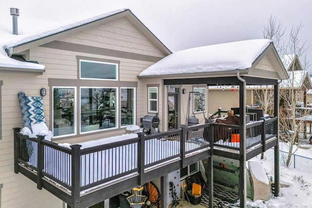 snow covered deck with grilling area