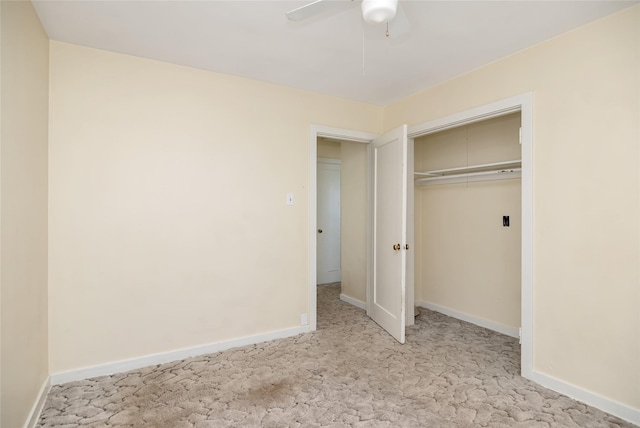 unfurnished bedroom with a closet, light carpet, ceiling fan, and baseboards