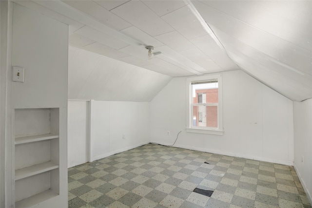 bonus room with vaulted ceiling, built in features, and baseboards