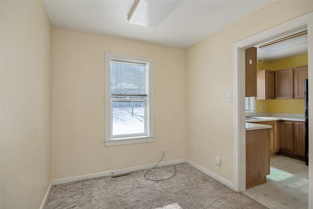 empty room with light colored carpet and baseboards