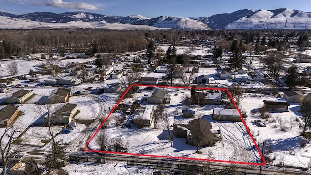 snowy aerial view featuring a mountain view