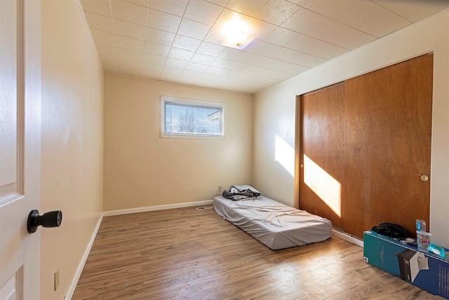 bedroom with wood finished floors and baseboards