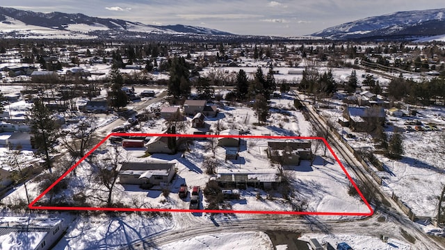 snowy aerial view featuring a mountain view