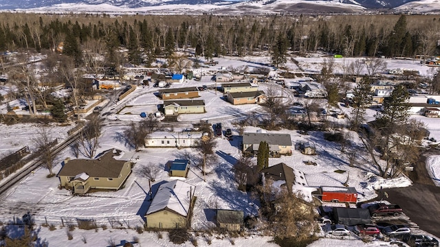 snowy aerial view with a mountain view