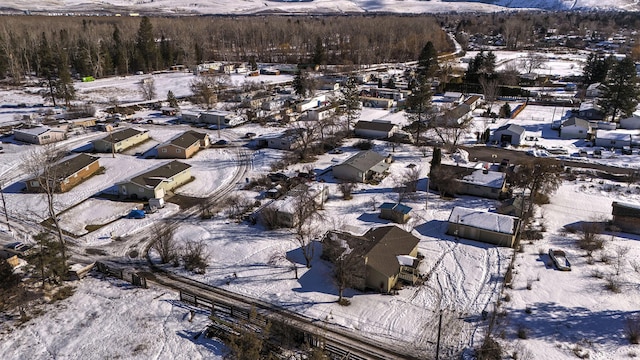 snowy aerial view featuring a mountain view