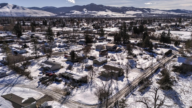 snowy aerial view featuring a mountain view